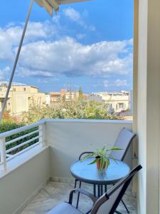 a balcony with a table and two chairs and a view at Nearby Sea Studio in Rethymno