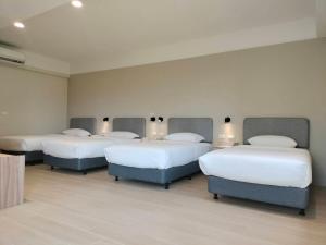 Rúm í herbergi á Chao Zhou 86 B&B