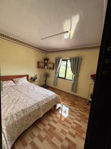 a bedroom with a bed and a window at 28 Homestay in Xuan An