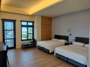 Rúm í herbergi á Chao Zhou 86 B&B