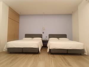 Rúm í herbergi á Chao Zhou 86 B&B