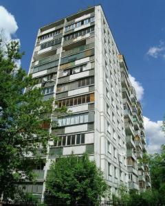 a tall white building with trees in front of it at InnDays on Sportivnaya in Moscow