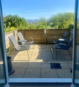 a group of chairs and tables on a patio at 4 bed Townhouse with spectacular views 4 miles from Cardiff 10min drive or train journey to city centre in Cardiff