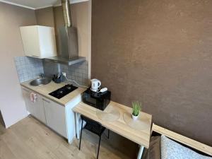 a small kitchen with a table and a counter top at Kopli Apartment in Tallinn