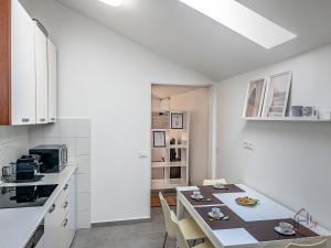 a kitchen with a table and chairs in a room at Sopra i tetti - Real Ligurian Caruggio in Varazze