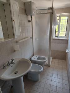 a bathroom with a sink and a toilet at Location Colle La Guardia in Borgo Montenero