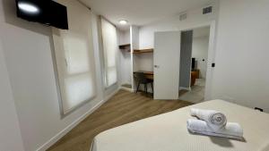 a room with a bed with two towels on it at Casa Martina in Zaragoza