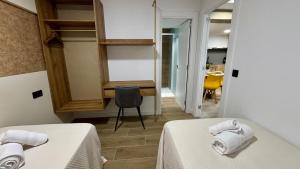 a room with two beds and a desk and a chair at Casa Martina in Zaragoza
