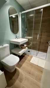 a bathroom with a toilet and a sink and a shower at Casa Martina in Zaragoza +10 photos