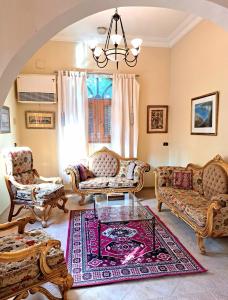 a living room with two couches and a table at Villa Belzoni in Luxor
