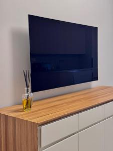 a large flat screen tv sitting on top of a cabinet at La Vela Luxury Apartment in Pescara