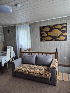 a living room with a bed and a dining table at Dariaus ir Gireno 7 in Zarasai