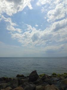 un grande specchio d'acqua con rocce e un cielo nuvoloso di Ваканционен Апартамент ad Aheloy