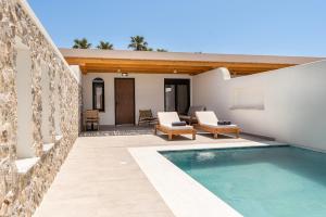 a patio with a swimming pool and a house at Casarela in Marmari
