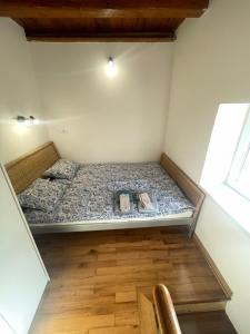 a bed in a room with two books on it at Apartmani Kersbaum in Belgrade