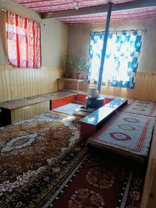 an empty room with a table and a rug at LSN Homestay By Soma Stays in Kaza