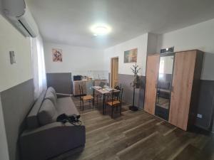 a living room with a couch and a table at Juhar Kiskunhalas in Kiskunhalas