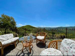 a patio with chairs and a glass table with a view at Villa Pietralunga Suite in Nicosia +11 photos