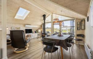 a dining room with a table and chairs at Holiday Home Bjerregårdsvej Hvide Sande in Bjerregård