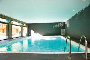 a large swimming pool in a building at T2 pic de l’ours Fontromeu in Font-Romeu