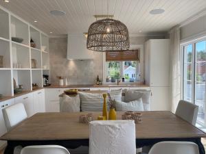 a kitchen and dining room with a table and chairs at No6 Risør in Risør