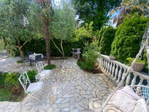 a patio with chairs and a fence and trees at Room TARA Malinska in Malinska +33 photos