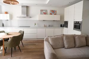 a living room with a couch and a table at High Street Apartments in Zandvoort
