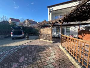 a car parked next to a house with a fence at Apartament tatarski PARKING! in Przemyśl