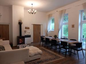 a living room with a table and chairs and a fireplace at Chata u Vajdov in Stará Lehota