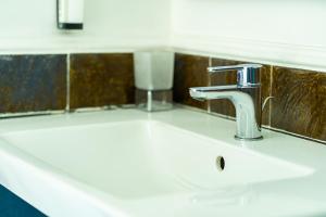 a sink in a bathroom with a faucet at Villa Acacia in Ponza +61 photos