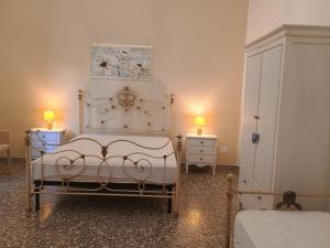 a bedroom with a white bed and two lamps on tables at Lucilla's House in Lido Marini