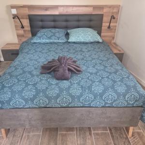 a bed with a stuffed animal on top of it at La Champoternoise in Belval-sous-Châtillon