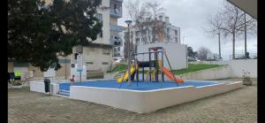 a playground with a slide in a building at Charming T1 apartment in Seixal in Aldeia de Paio Pires