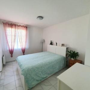 a bedroom with a bed and two windows at COSY HOME near DISNEYLAND PARIS in Serris