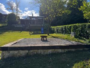a park with a bench in the grass at Pixie House - Mrežnica, private pier, hot tub in Gornji Zvečaj