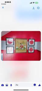 a row of framed pictures on a red wall at Regner-Quinto Real Estate Services in Cebu City +7 photos