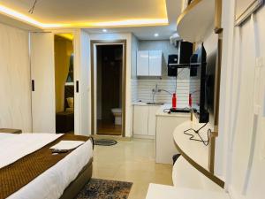 a hotel room with a bed and a kitchen at The Starfish Studio , Mussoorie road in Dehradun