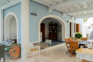a living room with a table and chairs at Villa Acacia in Ponza