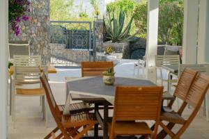 a table and chairs on a patio with a table and chairsktop at Villa Acacia in Ponza