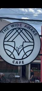 a sign that reads the wide awake cafe at Regner-Quinto Real Estate Services in Cebu City