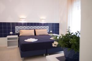 Postel nebo postele na pokoji v ubytování Residenza Punta Stendardo