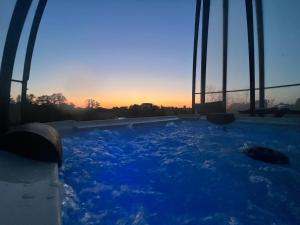 a hot tub with a view of a bridge at Exceptional Villa - Rural Charm in Momignies