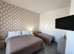 Postel nebo postele na pokoji v ubytování Hotel Bastione