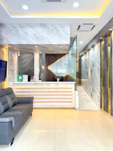 a lobby with a couch and a bar at AQ Hotel Kuala Lumpur in Kuala Lumpur