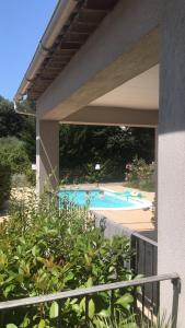 a view of a swimming pool from a balcony at La Romarine in Salernes