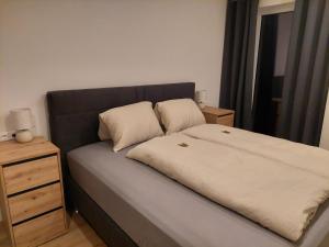 a bed with two pillows on it in a bedroom at Landhaus Seppi in Presseggersee