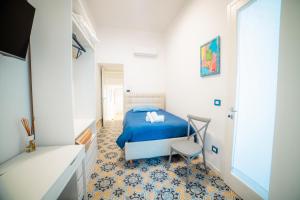 a bedroom with a bed and a chair in it at Dimora Carafa apartment in Lecce