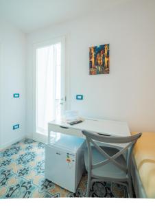 a desk with a chair in a room with a window at Dimora Carafa apartment in Lecce
