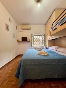 a bedroom with a bed with two towels on it at Casa Al Vicolo - Alley House in Seravezza