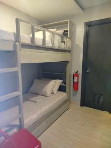 a bedroom with two bunk beds and a fire extinguisher at Regner-Quinto Real Estate Services in Cebu City
